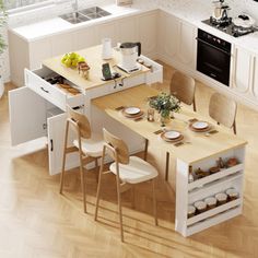 an overhead view of a kitchen and dining area with white cabinets, wood flooring and counter tops