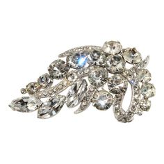 This is part of Chairish’s Costume Jewelry assortment.  Beautiful brooch embellished with clear navette (marquis shaped) and round rhinestones. We believe this piece dates to the 1950s. Marked Eisenberg Ice on the back. Brooch measures about 2.5 inches long and a little over 1.5 inches wide. Vintage Diamond Accented Brooches For Evening, Retro Wedding Brooches With Rhinestones, Vintage Crystal Embellished Brooches For Formal Events, Round Rock, The 1950s, Clear Rhinestones, Costume Jewelry, Dates, Vintage Jewelry