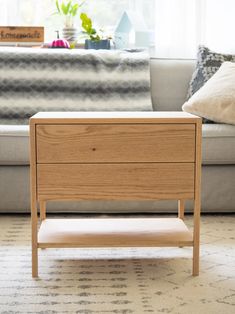 a living room scene with focus on the end table and sofa in the back ground