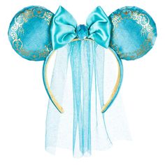 a blue mickey mouse ears with gold details and a bow on it's head