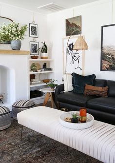 a living room filled with furniture and a fire place under a painting on the wall