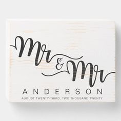 a wooden block with the word mr and mrs on it, in black ink against a white background