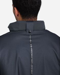 the back of a man's jacket with an open hood and zippers on it