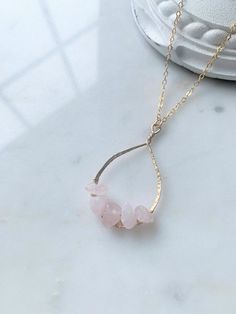 This raw rose quartz pendant necklace is handmade with hammered 14k gold filled wire and genuine rose quartz nugget beads. The clasp and chain are also 14k gold filled. This necklace also comes in sterling silver finish.   This necklace is available in 16", 18", 20" or 24" style. Beads measure 7-10 mm in size apiece. Each bead is hand picked during the crafting of each necklace so the size, shape and color will vary slightly in each stone.  We aim to process most orders in 3 - 5 business days, u Gold Wire Wrapped Rose Quartz Jewelry, Gold Teardrop Rose Quartz Jewelry, Gold Wire-wrapped Rose Quartz Necklace, Gold Wire Wrapped Rose Quartz Necklace, Gold Rose Quartz Wire Wrapped Necklace, Raw Rose Quartz Necklace, Rose Quartz Pendant Necklace, Raw Crystal Pendant, Rose Quartz Necklace Pendants