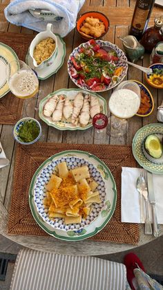 a table full of food on plates and bowls