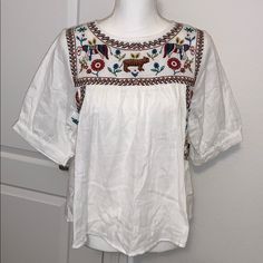 Nwt Size Small 22” Pit To Pit 23” Length Beautiful Embroidery. Very Light White Bohemian Top With Geometric Embroidery, White Folk Embroidered Top With Floral Print, White Folk Embroidered Top With Embroidered Hem, White Embroidered Folk Tops, White Bohemian Top With Intricate Embroidery, White Embroidered Neckline Top For Spring, Winter Wear Women, Ruffle Top Blouses, Black Floral Top