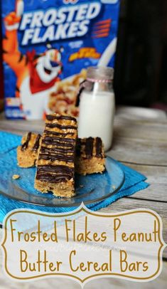 frosted flakes peanut butter cereal bars on a blue plate with a carton of frosted flakes in the background