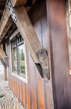 an old wooden building with a window on the side