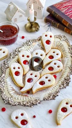 some cookies are sitting on a plate with jam in the middle and other decorations around them