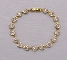 "New, updated design featuring high quality cubic zirconia! This sparkling bracelet will surely add brilliance to your special day! This bracelet features AAA grade prong set cubic zirconia in a halo, framed design set in brilliant yellow gold. Bracelet measures 1/4\" wide and sizes are available in multiple options making it perfect for the bride or great bridesmaid jewelry gift! Jewelry is rhodium plated, which is non-tarnishing, and nickel free. Optional matching earrings measuring 3/8\" and Crystal Wedding Bracelet, Bridesmaid Jewelry Gift, Coordinates Bracelet, Earrings And Necklace Set, Sparkle Bracelet, Cz Bracelet, Round Halo, Crystal Jewelry Sets, Crystal Headpiece