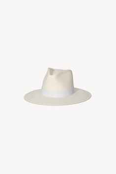 A classic fedora style made with packable straw. The structured fit creates a beautiful modern shape while staying true to the timeless design of our classic fedora. | Spring Summer 2021 Collection by Janessa Leoné. Chic Adjustable Fedora With Flat Crown, Classic Flat Brim Hats For Spring, White Fedora With Curved Brim, Chic Fitted Panama Hat With Flat Brim, Chic Fedora With Flat Crown For Spring, Adjustable Flat Brim Unlined Fedora, Chic Fitted Flat Brim Panama Hat, Modern Flat Brim Hat For Spring, Chic Flat Crown Fedora For Spring