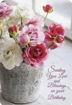 a bucket filled with lots of pink and white flowers