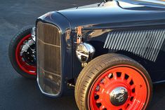 an orange and black car parked in a parking lot