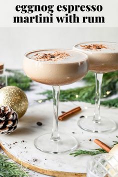 eggnog espresso martini with rum in coupe glasses on a tray surrounded by christmas decorations