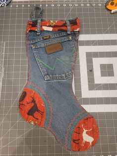 an old pair of jeans has been made to look like a stocking with animals on it