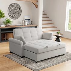 a living room scene with focus on the couch and stairs in the backround