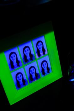 a computer screen with faces on it in the dark