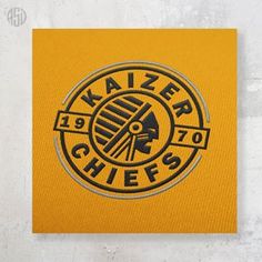 a yellow sticker with the word kaiser chiefs on it in black and gold foil