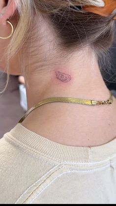 a woman with a small tattoo on her neck