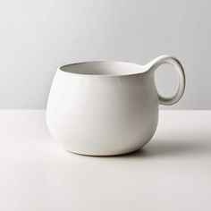 a white porcelain pitcher sitting on top of a table