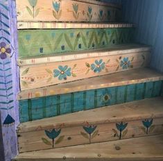 some steps painted with flowers on them and blue trim around the bottom one step is made out of wooden planks