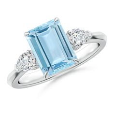 an aqua blue topazte and diamond ring with three diamonds on the sides, set in