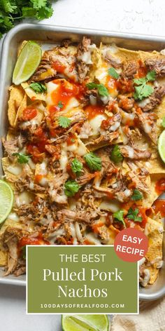 the best pulled pork nachos recipe on a tray with cilantro and lime