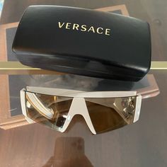 Versace White And Gold Sunglasses Case Included White Shield Sunglasses With Uv Protection, Designer White Glass Sunglasses, Luxury White Anti-reflective Sunglasses, White Shield Sunglasses With Mirrored Lenses, White Shield Sunglasses With Tinted Glass Lenses, White Glass Shield Sunglasses With Mirrored Lenses, Modern White Glass Shield Sunglasses, Versace Accessories, Eye Wear