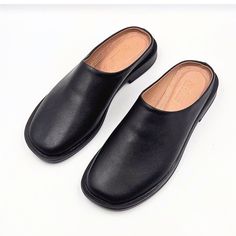 Materials: 100% Genuine Leather Sole: Comfort-contoured Heel: Flat Fit: Snug  Size Chart: For sizing information, please see the size chart included in the picture gallery or use online shoes size converter https://www.gigacalculator.com/converters/shoe-size-converter.php Elevate your style with these sleek Leather Mules for Women: Flat Shoes for Women, Gift for Women  The modern square-toe design adds a touch of sophistication, while the smooth leather construction ensures comfort and quality. Black Leather Slip-on Mules, Black Closed Toe Slip-ons With Leather Footbed, Faux Leather Slip-on Mules With Leather Footbed, Classic Slip-on Mules With Round Toe, Casual Mules With Leather Sole For Business, Slip-on Mules With Round Toe For Business, Flat Heel Faux Leather Mules With Removable Insole, Business Clogs With Leather Footbed And Round Toe, Business Slip-on Mules With Round Toe