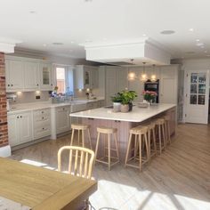 a large kitchen with an island in the middle