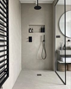 a bathroom with a shower, mirror and shelf on the wall next to the sink