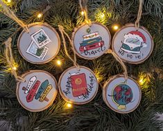 christmas ornaments hanging from a tree with lights