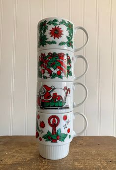 stack of coffee mugs decorated with christmas decorations