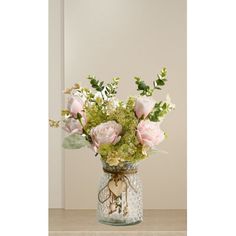 a vase filled with lots of flowers on top of a table