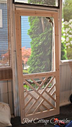 an open wooden door sitting next to a window