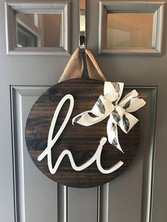 a door hanger with the word hope painted on it and a bow tied to it