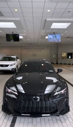 two cars are parked in a showroom