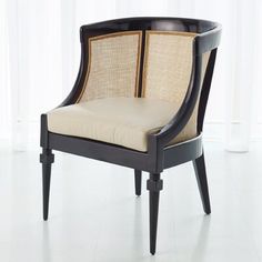 a black and beige chair sitting in front of a window