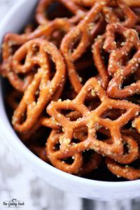 a bowl filled with pretzels sitting on top of a table