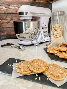 cookies are on the counter next to a mixer