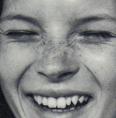 a black and white photo of a smiling woman