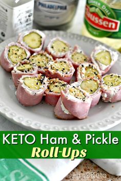 keto ham and pickle roll ups on a white plate