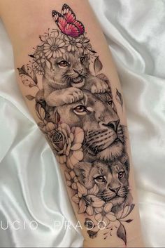 a woman's leg with an animal and flower tattoo on it