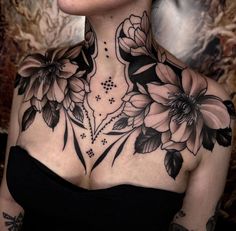 a woman with black and white flowers on her chest