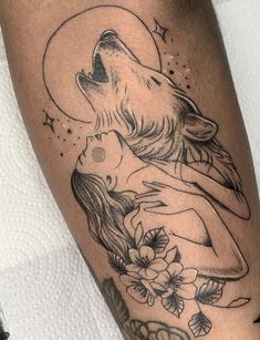 a woman with a wolf tattoo on her leg