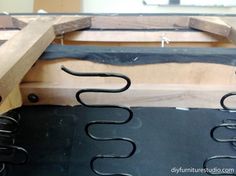 the back end of a wooden bench being constructed with metal brackets and wood planks