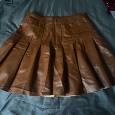 I Brought The Skirt But Was Never Able To Wear It Because The Waist Line Is Small Although I Wear A Size Small So Originally This Is A Woman’s Skirt But Because It Fits So Small A Child Can Fit This. Removed The Tag Because I Thought I Would Be Able To Wear It But It Is Brand New Never Worn. Brown Faux Leather Mini Skirt For Party, Party Faux Leather Brown Mini Skirt, Brown Party Skort For Spring, Brown Skirt For School Spring Season, Brown Faux Leather Skirt For Party, Trendy Brown Faux Leather Mini Skirt, Trendy Pleated Faux Leather Skirt, Fitted Brown Bottoms For School, Brown Skort For School