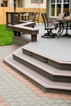 an outdoor patio with steps leading up to the deck