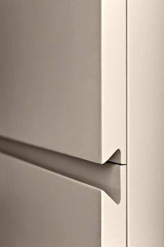 a white refrigerator with a handle on it's door