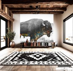 a large bison is on the wall in an empty room with wooden floors and windows